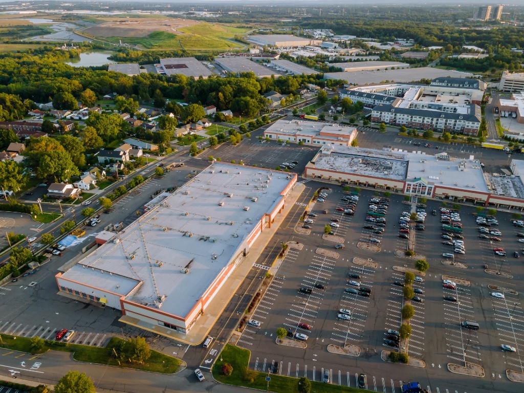Aerial view of commercial buildings and parking for context on yields